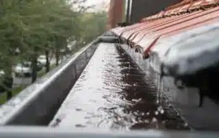 Conifer Gutter Services: Rainwater flowing smoothly through roof gutters, ensuring your home’s exterior stays protected from water damage and drainage issues.