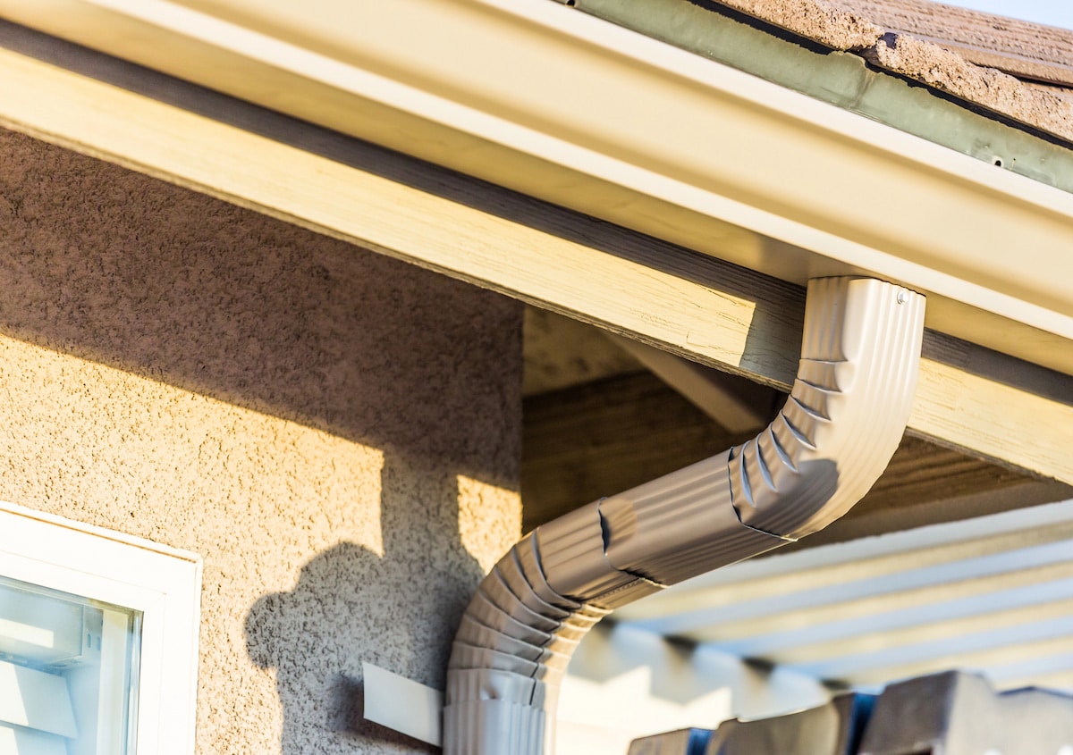 How Long Do Copper Gutters Last House gutter and downspout in sunlight