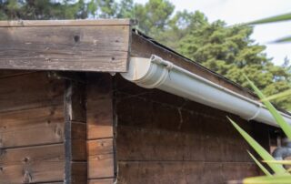 Wooden shed with gutter system - Log Homes & Gutters Preventing Stain Lines and Rot