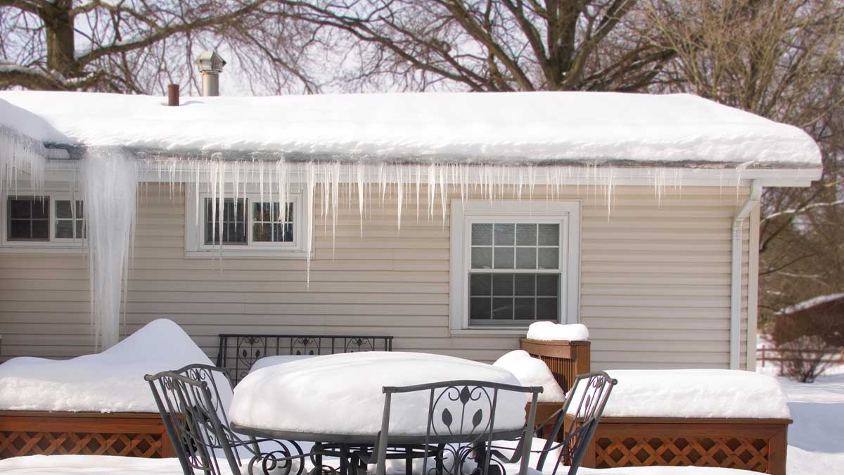 Patio Icicles Hazard? Heated Outlet + Diverter to Safe Zone Snow-covered house with icicles and patio furniture. Patio Icicles Hazard? Heated Outlet + Diverter to Safe Zone