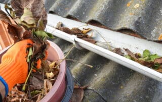 Cleaning leaves from a roof gutter